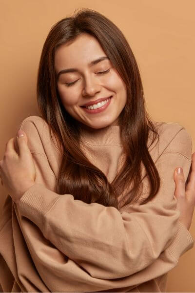 nd affirming therapist woman hugging herself