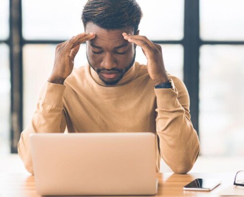 sensory systems black man touching temples