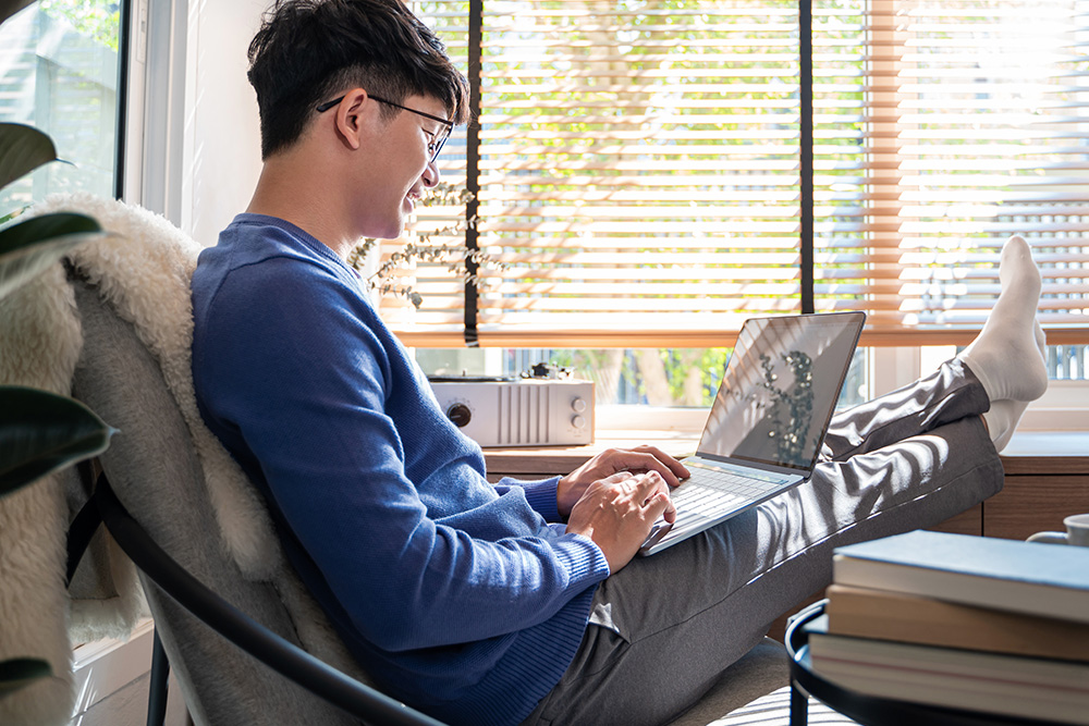 Neurodivergent therapist on a laptop exploring the Neurodiversity Training Center resource library.